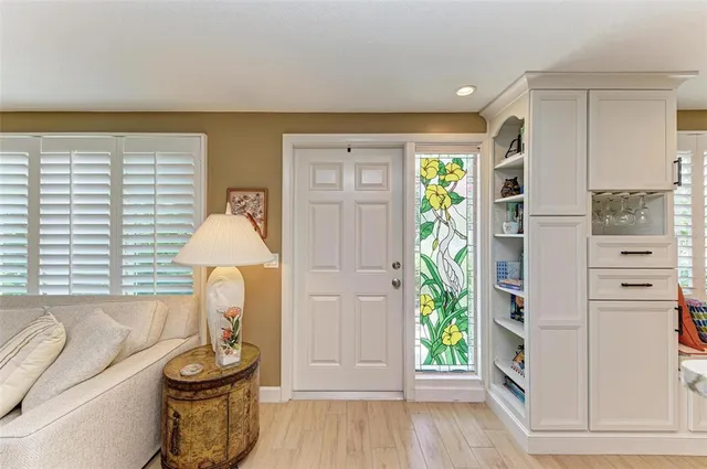 a living room with furniture and large windows