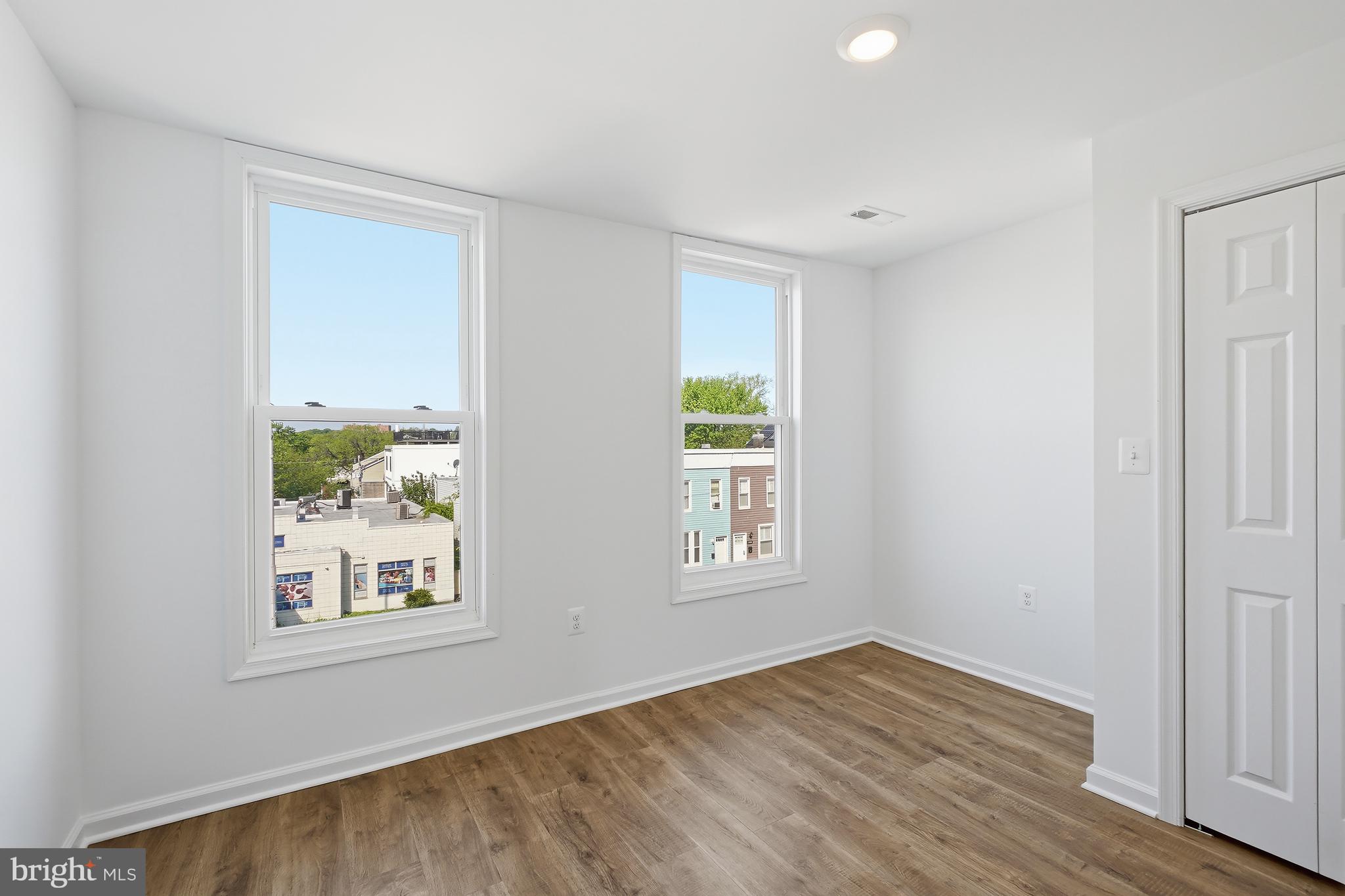 3731 Falls Road Baltimore, MD 21211 - Photo 21 of 30 an empty room with wooden floor and windows