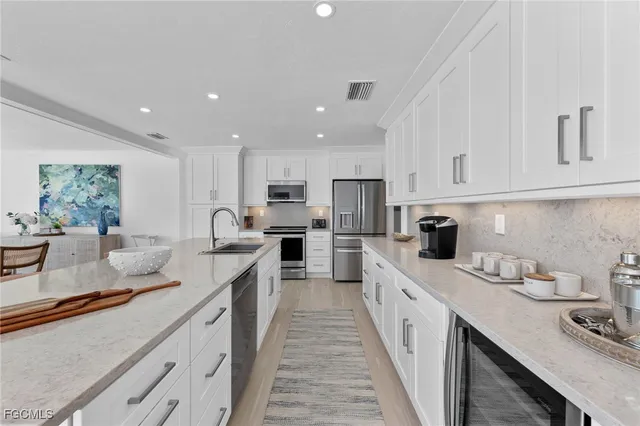 a kitchen with a sink and chairs