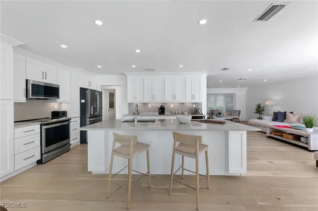 a view of a dining room with furniture large windows and wooden floor