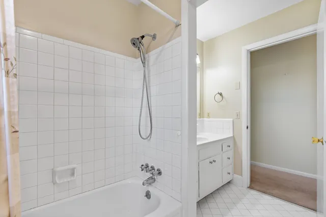 a bathroom with a bathtub a shower a sink and a mirror