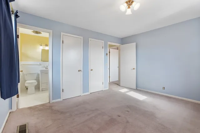 a view of an empty room and a bathroom