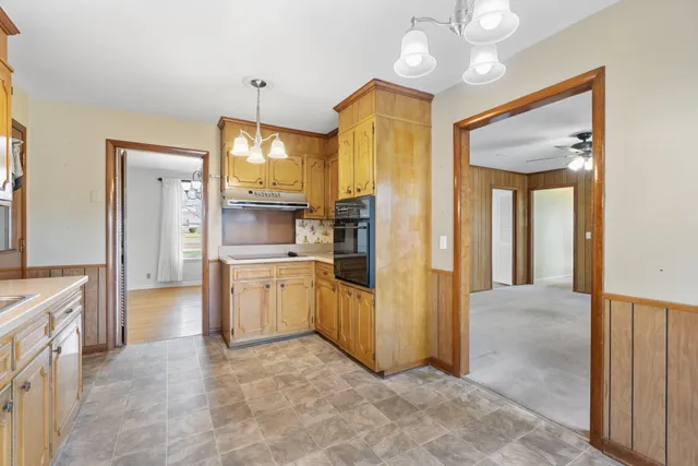 a large kitchen with a large window and stainless steel appliances