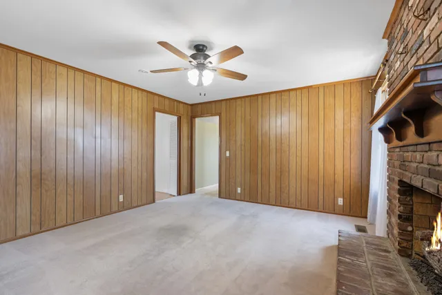 a view of an empty room with a fireplace