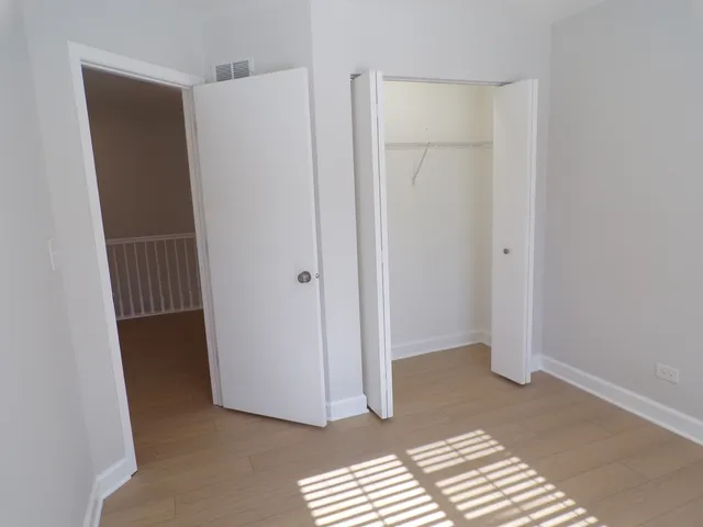 a bathroom with a granite countertop sink and a toilet