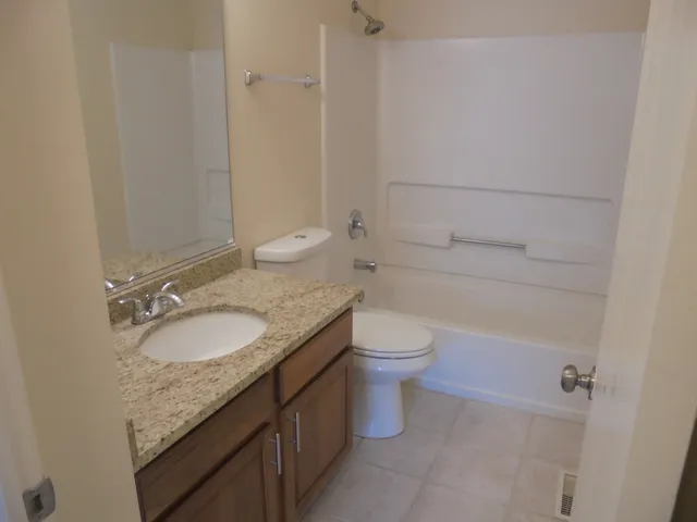 a view of a closet area with hardwood floor