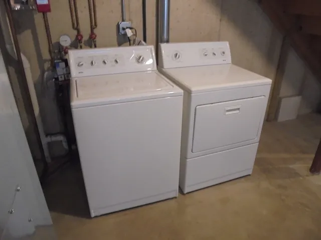 a front view of a house with a parking space