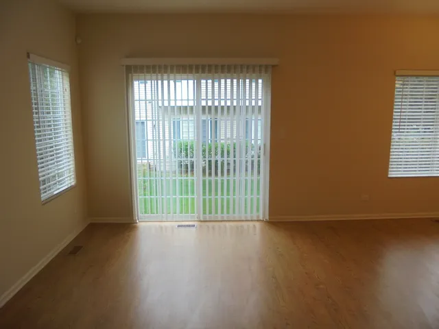 a view of a room with wooden floor and a window