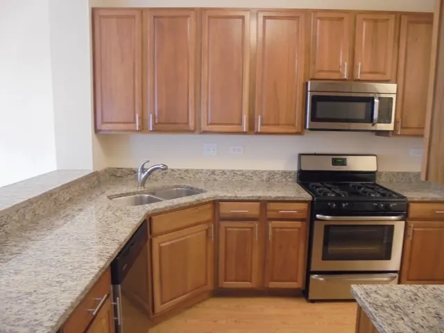 a kitchen with granite countertop stainless steel appliances and granite counter tops