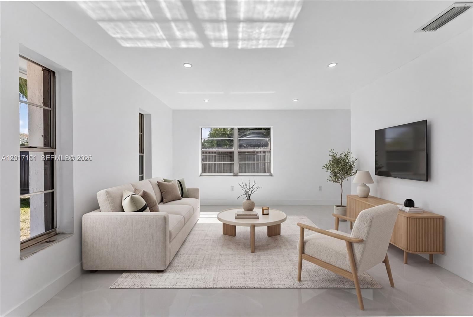 10210 Southwest 175th Street Miami, FL 33157 - Photo 12 of 25 a living room with furniture and a flat screen tv