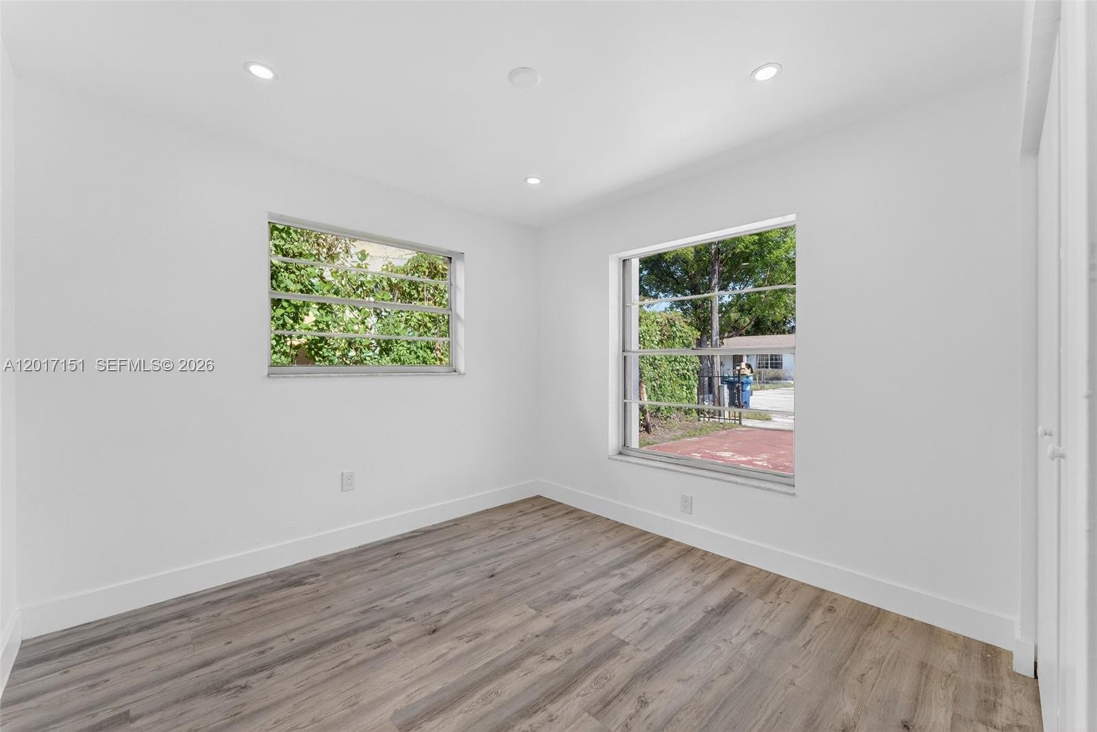 10210 Southwest 175th Street Miami, FL 33157 - Photo 14 of 25 an empty room with wooden floor and windows