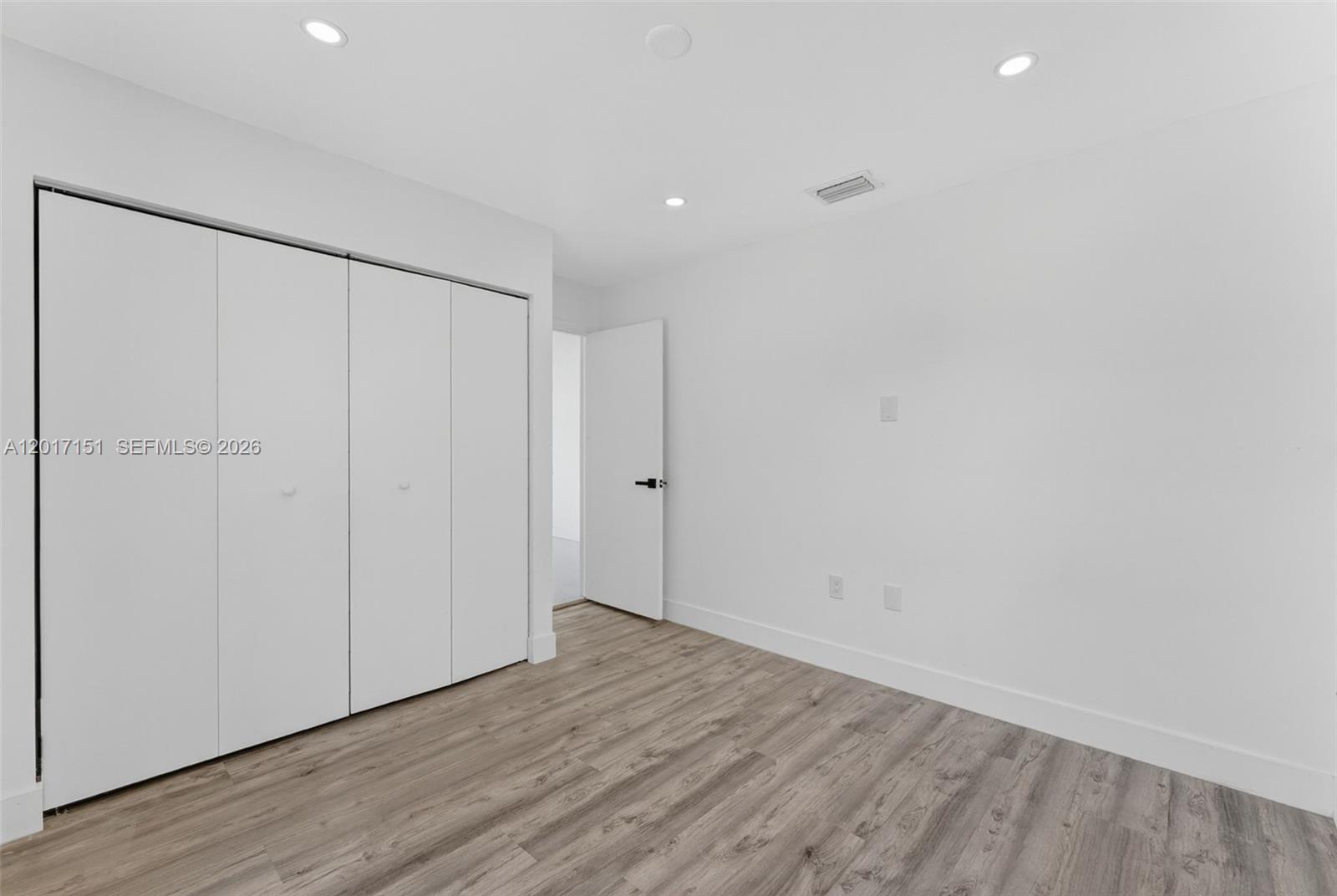 10210 Southwest 175th Street Miami, FL 33157 - Photo 16 of 25 a view of an empty room with wooden floor