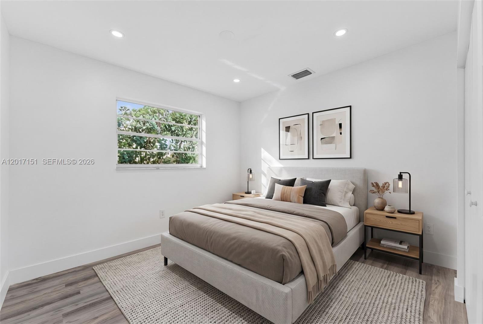 10210 Southwest 175th Street Miami, FL 33157 - Photo 18 of 25 a bedroom with a bed and a large window