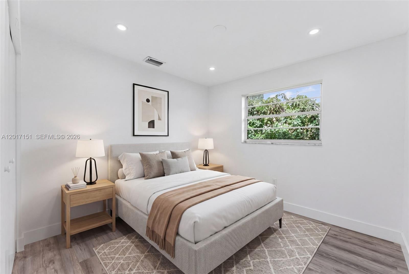 10210 Southwest 175th Street Miami, FL 33157 - Photo 21 of 25 a bedroom with a bed and a painting on the wall