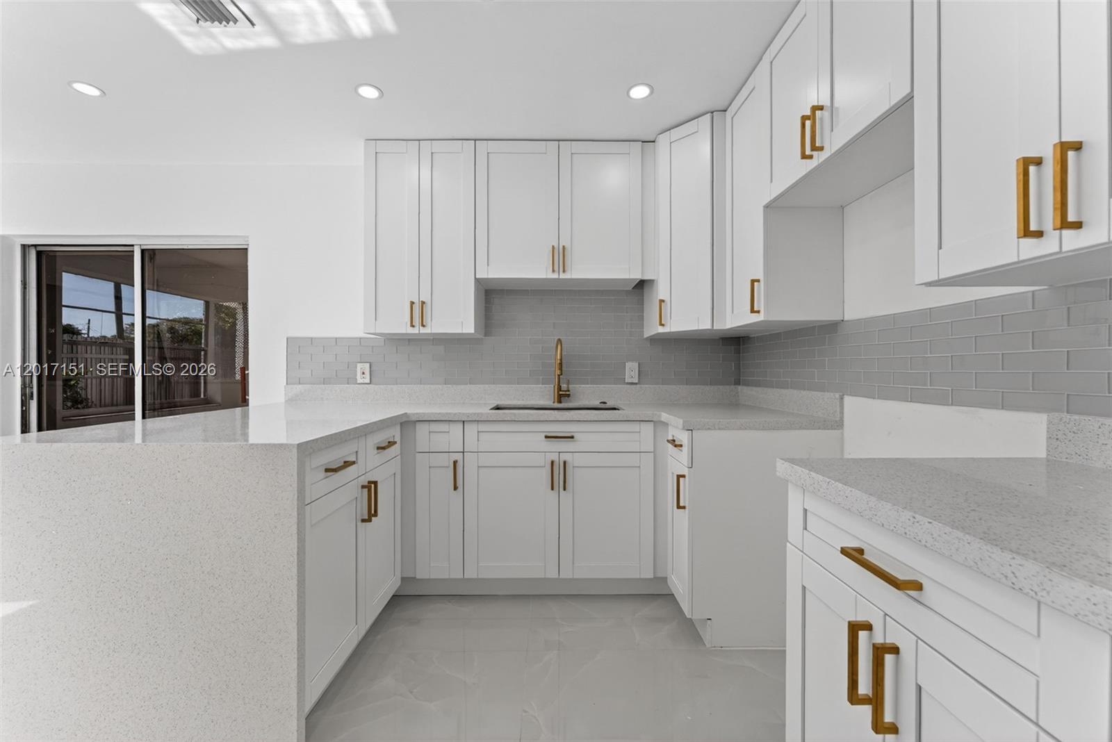 10210 Southwest 175th Street Miami, FL 33157 - Photo 6 of 25 a kitchen with granite countertop white cabinets and white appliances