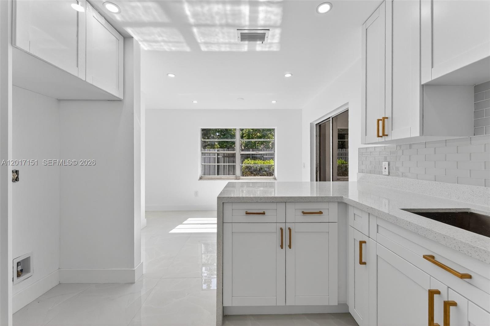 10210 Southwest 175th Street Miami, FL 33157 - Photo 7 of 25 a kitchen with white cabinets and window