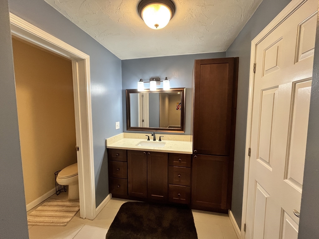 1830 Main Street, Unit 21 Tewksbury, MA 01876 - Photo 12 of 15 a bathroom with a sink and a mirror