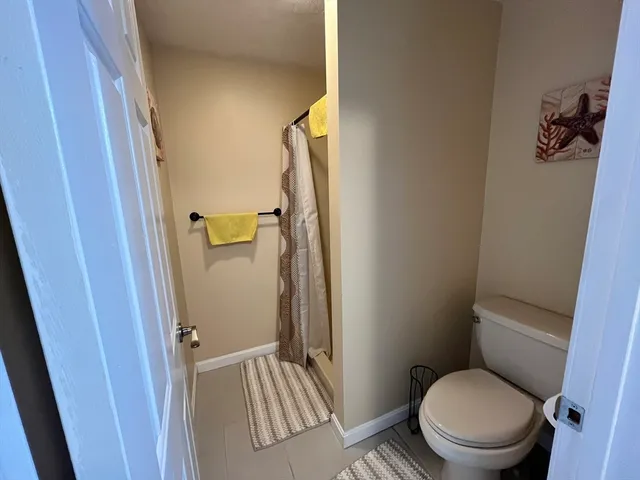 a bathroom with a toilet and a shower