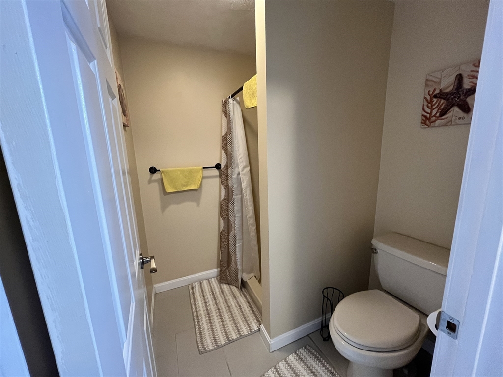 1830 Main Street, Unit 21 Tewksbury, MA 01876 - Photo 14 of 15 a bathroom with a toilet and a shower