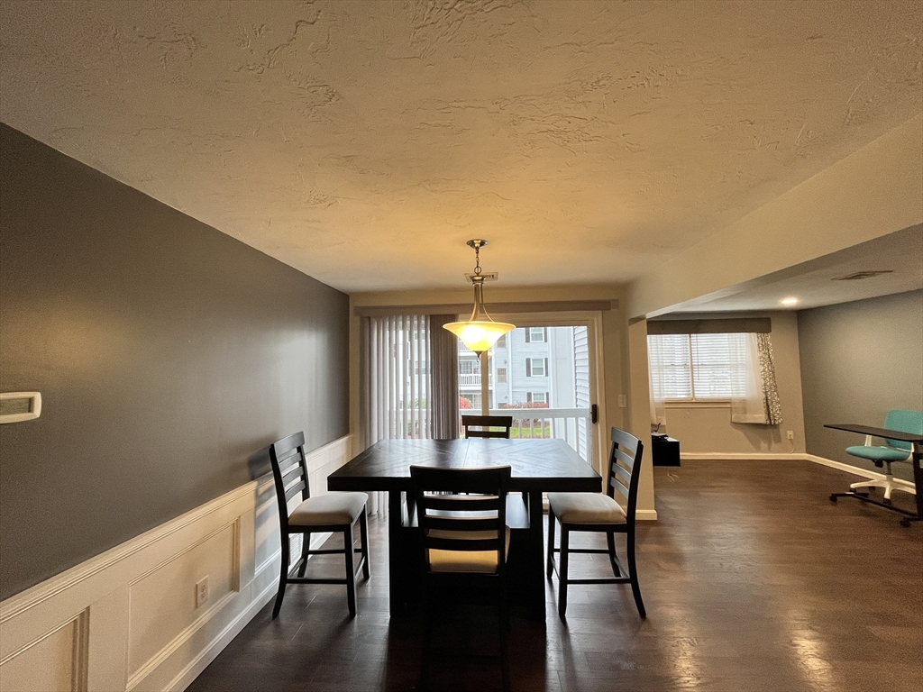 1830 Main Street, Unit 21 Tewksbury, MA 01876 - Photo 4 of 15 a view of a a dining room with furniture window and wooden floor