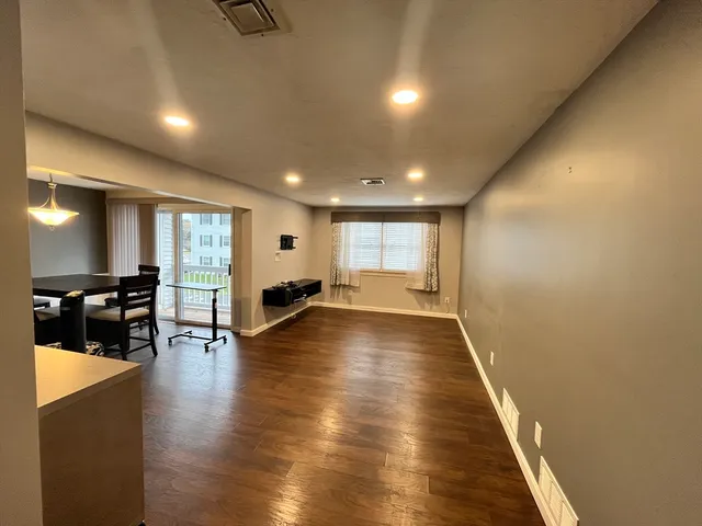 a view of a room with furniture and wooden floor
