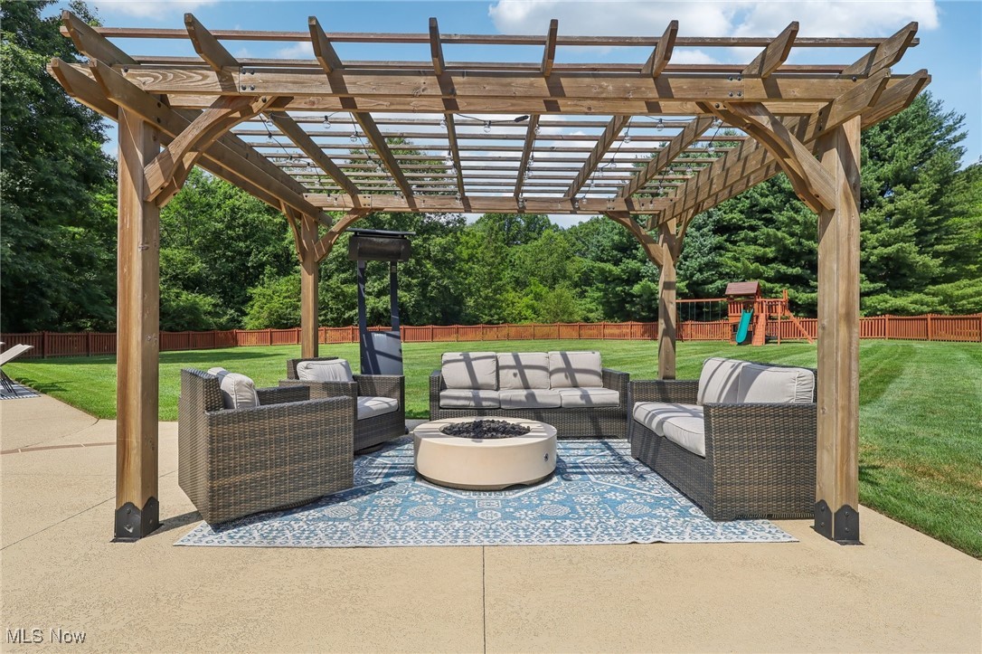 230 South Medina Line Road Akron, OH 44321 - Photo 39 of 50 Fenced backyard featuring an outdoor living space with a fire pit, a patio area, and a pergola