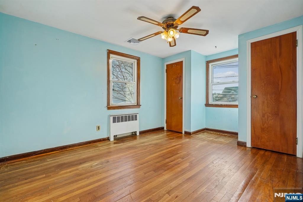 404 Burroughs Terrace Union, NJ 07083 - Photo 13 of 19 an empty room with wooden floor and windows