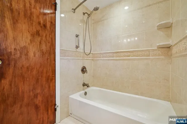 a bathroom with a bathtub and shower