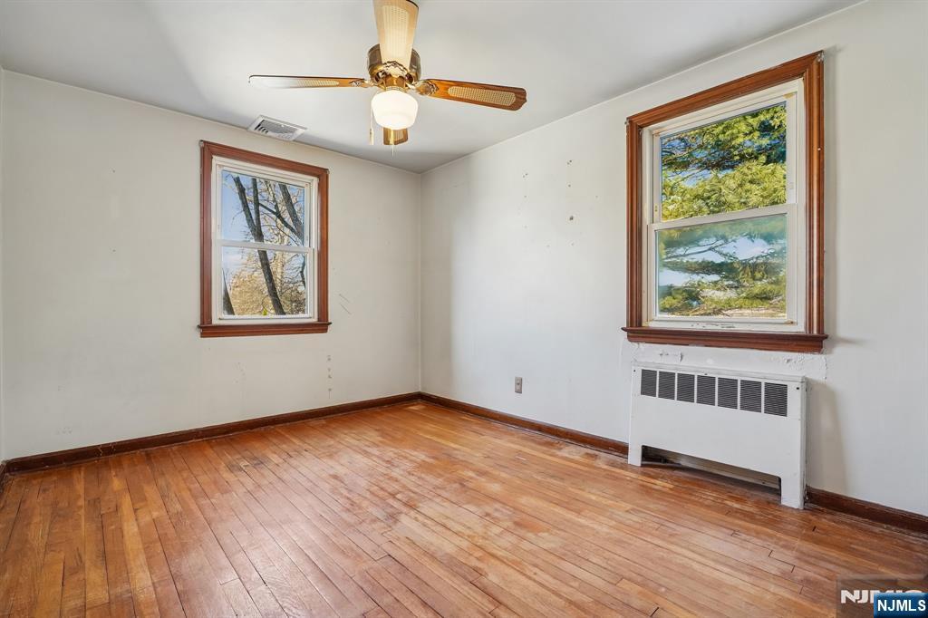 404 Burroughs Terrace Union, NJ 07083 - Photo 16 of 19 a view of an empty room with wooden floor and a window