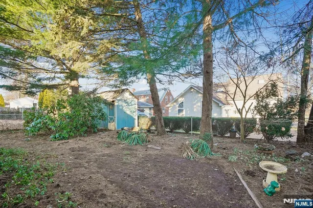 a view of a backyard with large trees