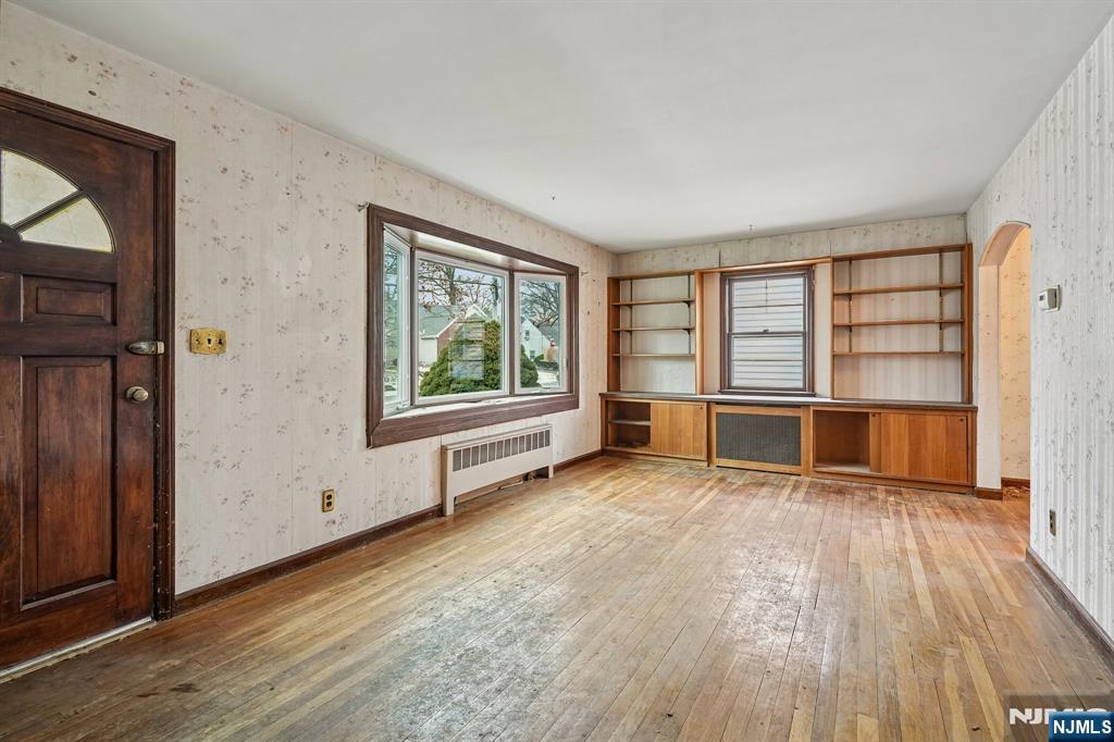 404 Burroughs Terrace Union, NJ 07083 - Photo 4 of 19 an empty room with wooden floor and windows