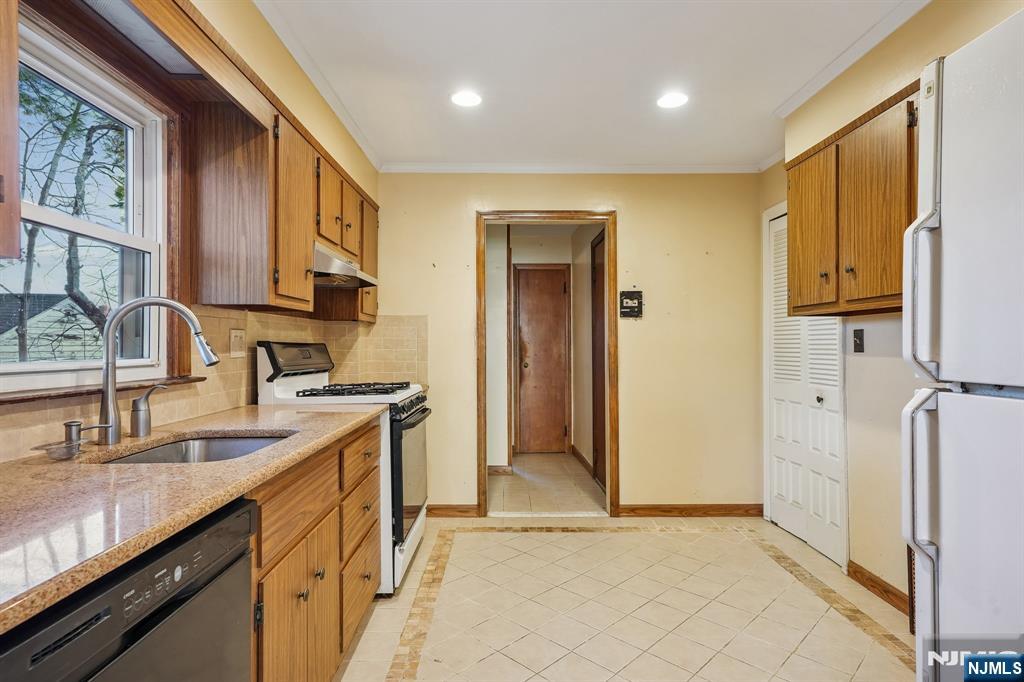 404 Burroughs Terrace Union, NJ 07083 - Photo 7 of 19 a kitchen with stainless steel appliances granite countertop a sink and a refrigerator