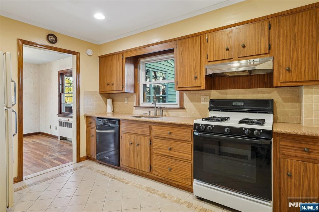 404 Burroughs Terrace Union, NJ 07083 - Photo 9 of 19 a kitchen with granite countertop cabinets stainless steel appliances and a window