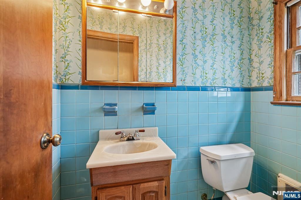 404 Burroughs Terrace Union, NJ 07083 - Photo 10 of 19 a bathroom with a toilet sink and mirror