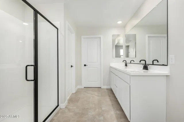 a bathroom with a double vanity sink and mirror