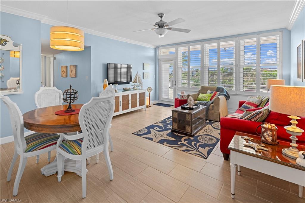 a living room with furniture and a floor to ceiling window