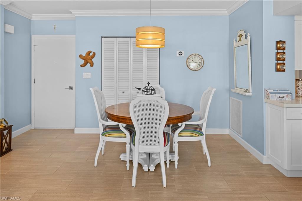 240 Seaview Court, Unit 413 Marco Island, FL 34145 - Photo 11 of 35 a view of a dining room with furniture and chandelier