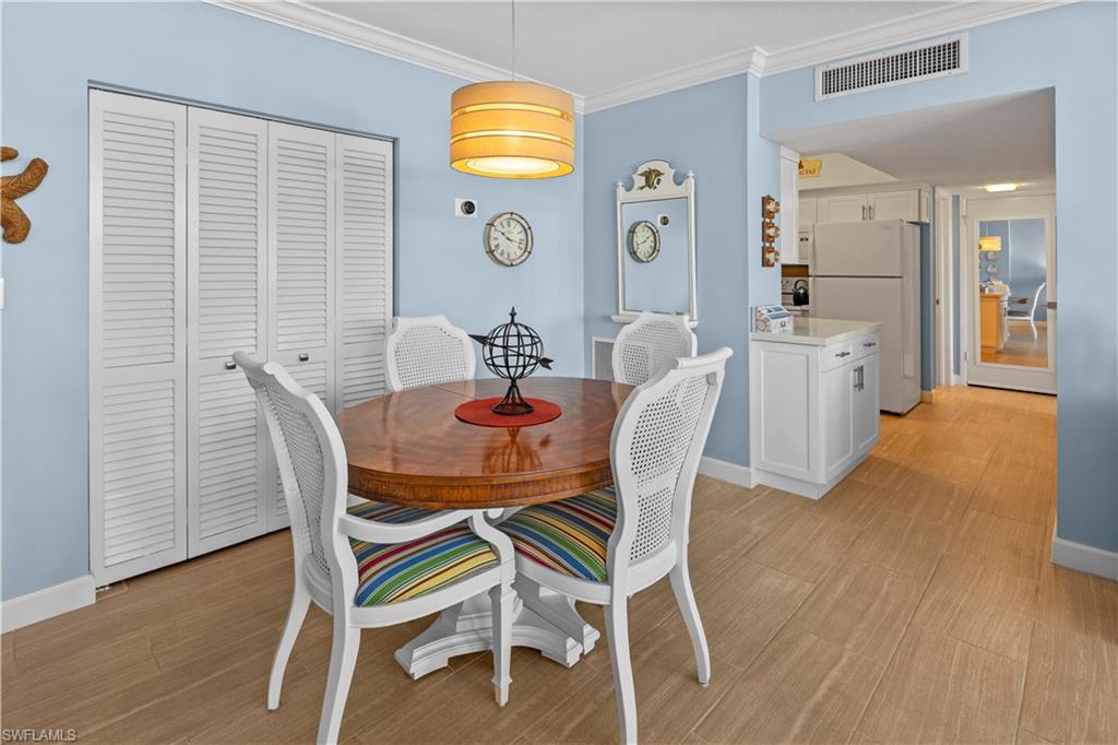 240 Seaview Court, Unit 413 Marco Island, FL 34145 - Photo 13 of 35 a view of a dining room with furniture and wooden floor