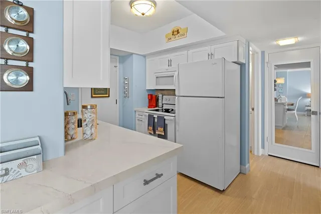 a kitchen with stainless steel appliances a refrigerator and a stove