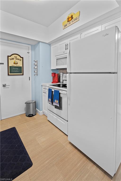 240 Seaview Court, Unit 413 Marco Island, FL 34145 - Photo 18 of 35 a kitchen with a refrigerator and a stove top oven