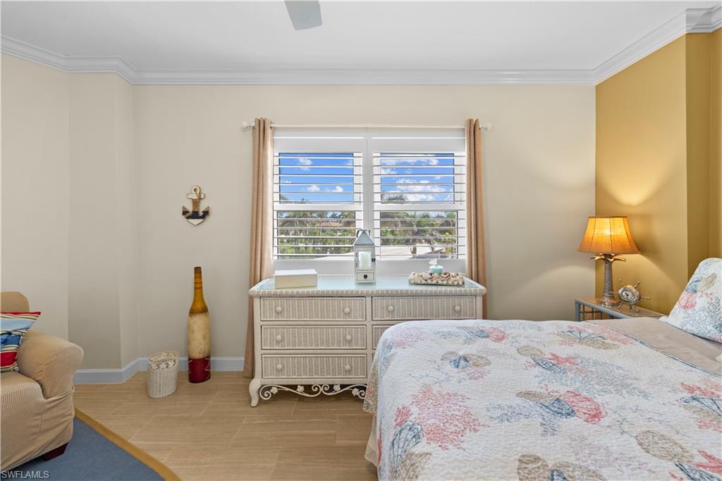 240 Seaview Court, Unit 413 Marco Island, FL 34145 - Photo 21 of 35 a bedroom with a bed and a window