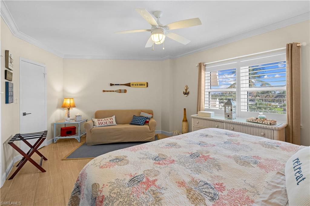 240 Seaview Court, Unit 413 Marco Island, FL 34145 - Photo 22 of 35 a bedroom with a bed and a window