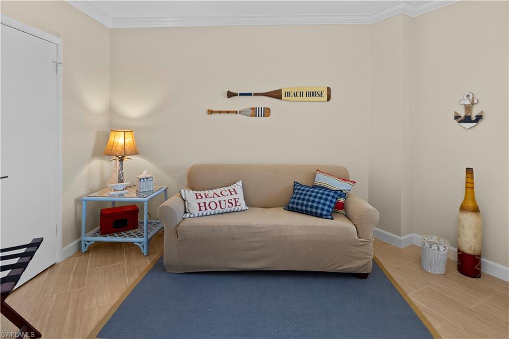 240 Seaview Court, Unit 413 Marco Island, FL 34145 - Photo 23 of 35 a bedroom with furniture and a lamp