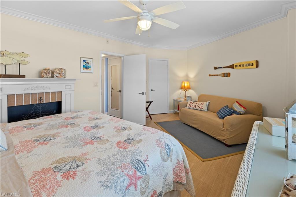 240 Seaview Court, Unit 413 Marco Island, FL 34145 - Photo 24 of 35 a bedroom with a bed and a couch