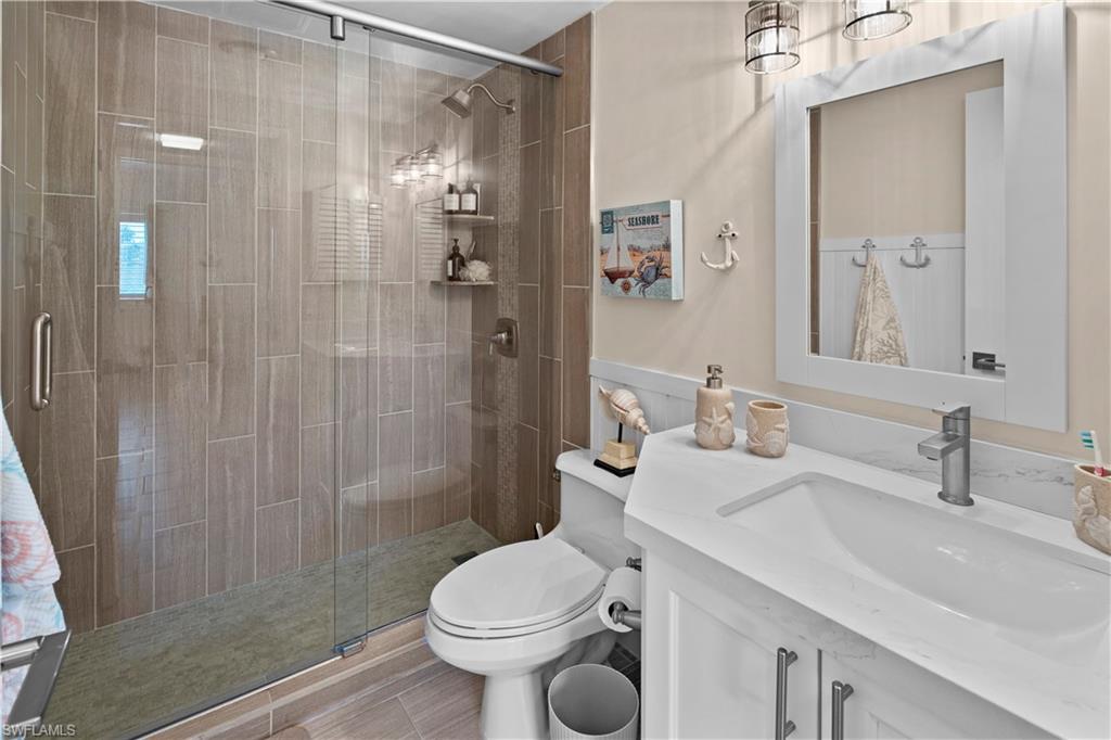 240 Seaview Court, Unit 413 Marco Island, FL 34145 - Photo 25 of 35 a bathroom with a sink toilet and shower