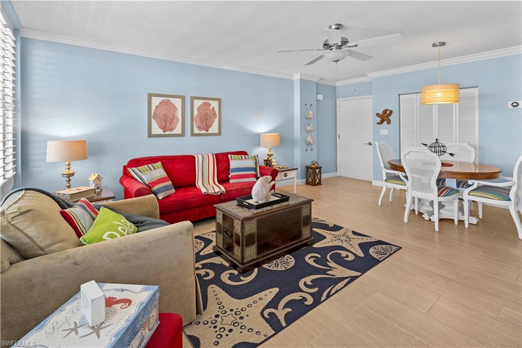 240 Seaview Court, Unit 413 Marco Island, FL 34145 - Photo 4 of 35 a living room with furniture and wooden floor