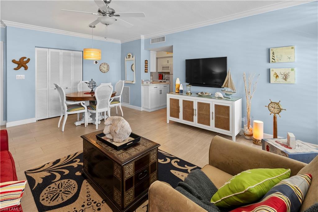 240 Seaview Court, Unit 413 Marco Island, FL 34145 - Photo 6 of 35 a living room with furniture and a flat screen tv