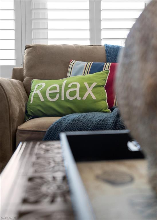 240 Seaview Court, Unit 413 Marco Island, FL 34145 - Photo 8 of 35 a wooden bench sitting in a bedroom next to a window