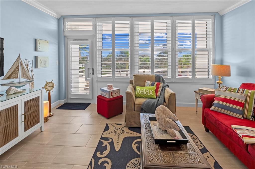 240 Seaview Court, Unit 413 Marco Island, FL 34145 - Photo 9 of 35 a living room with furniture and a floor to ceiling window