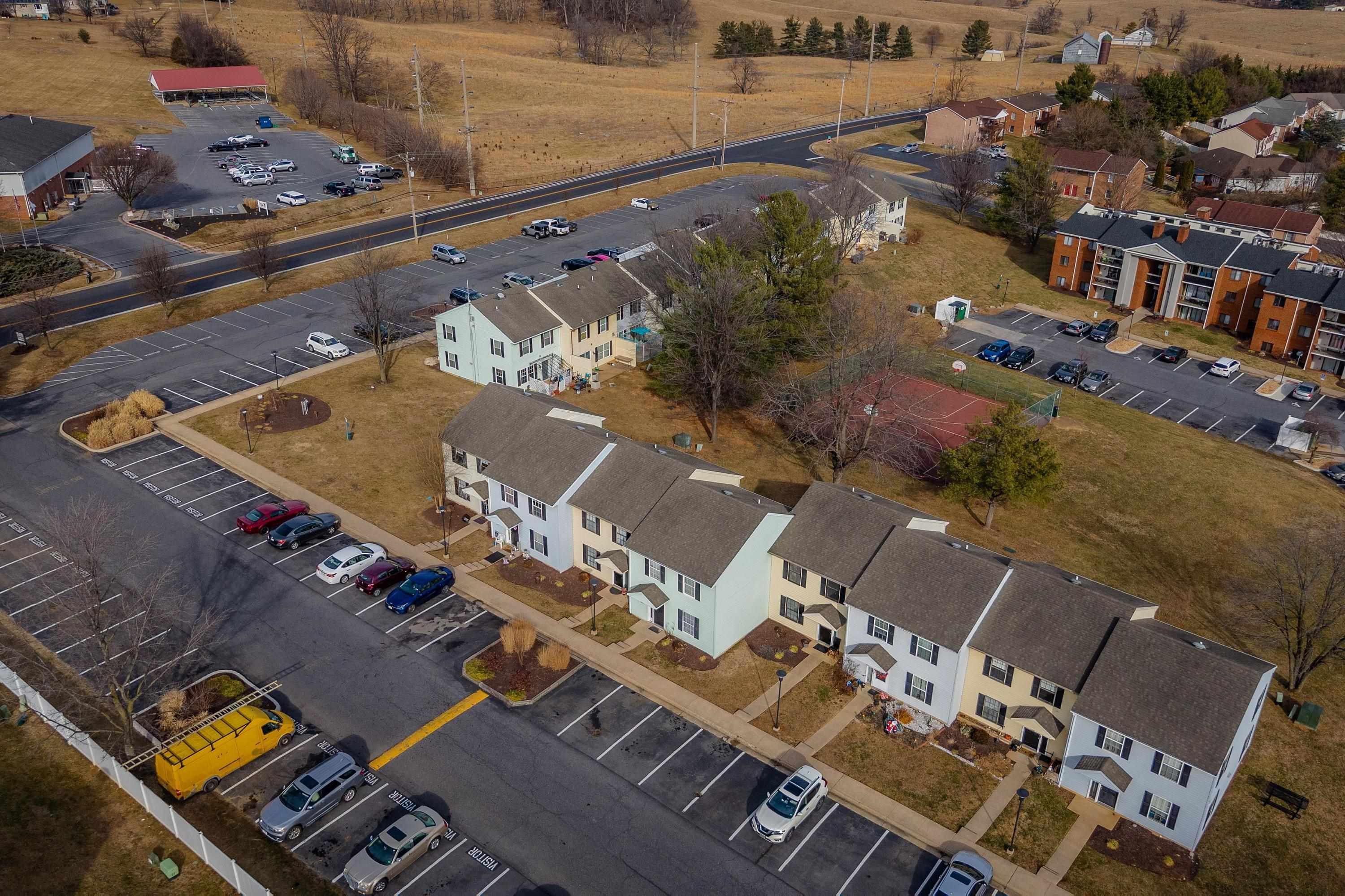 1211 Old Furnace Road Harrisonburg, VA 22802 - Photo 33 of 55 The aerial photo highlights the townhouse location within the Madison Manor neighborhood, the abundance of parking spaces, and the convenient location within the city of Harrisonburg.